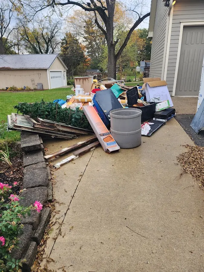 Dumpster being loaded with debris for Commercial Dumpster Rental in Heflin